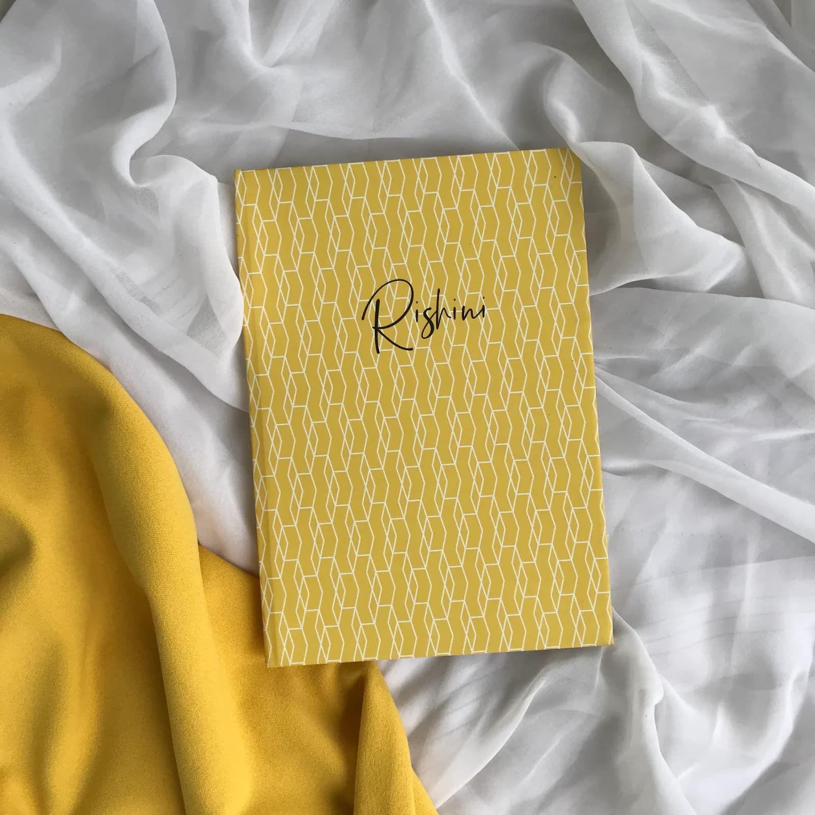 2027 Dated Diary — One Day per Page photographed on softly styled fabric
