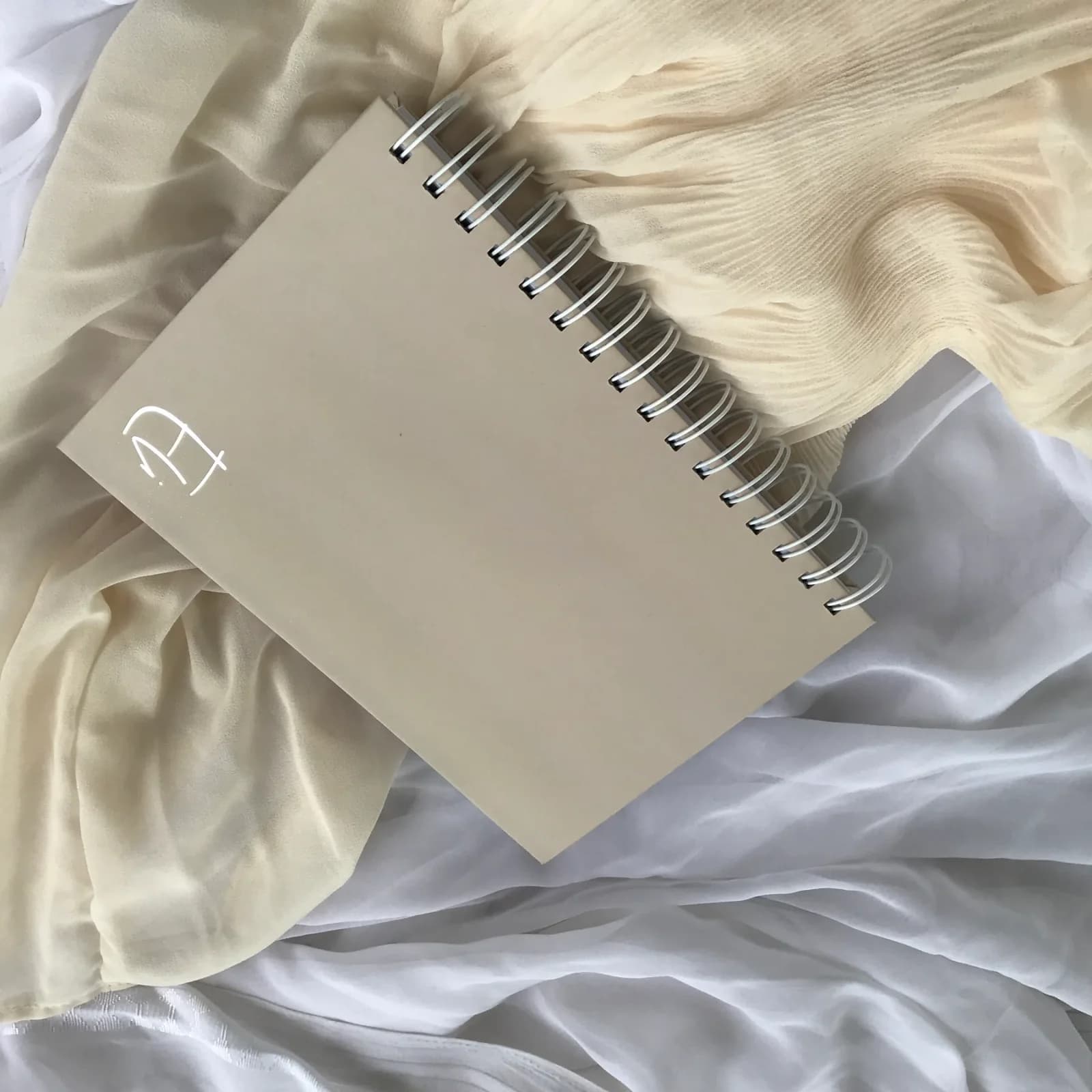 Undated Weekly Planner photographed on softly styled fabric