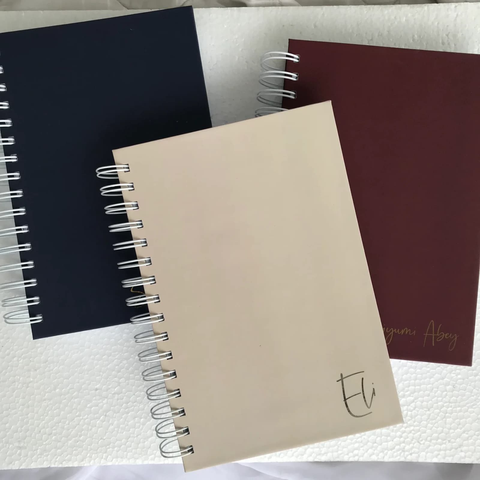Custom Cover Notebook photographed on softly styled fabric